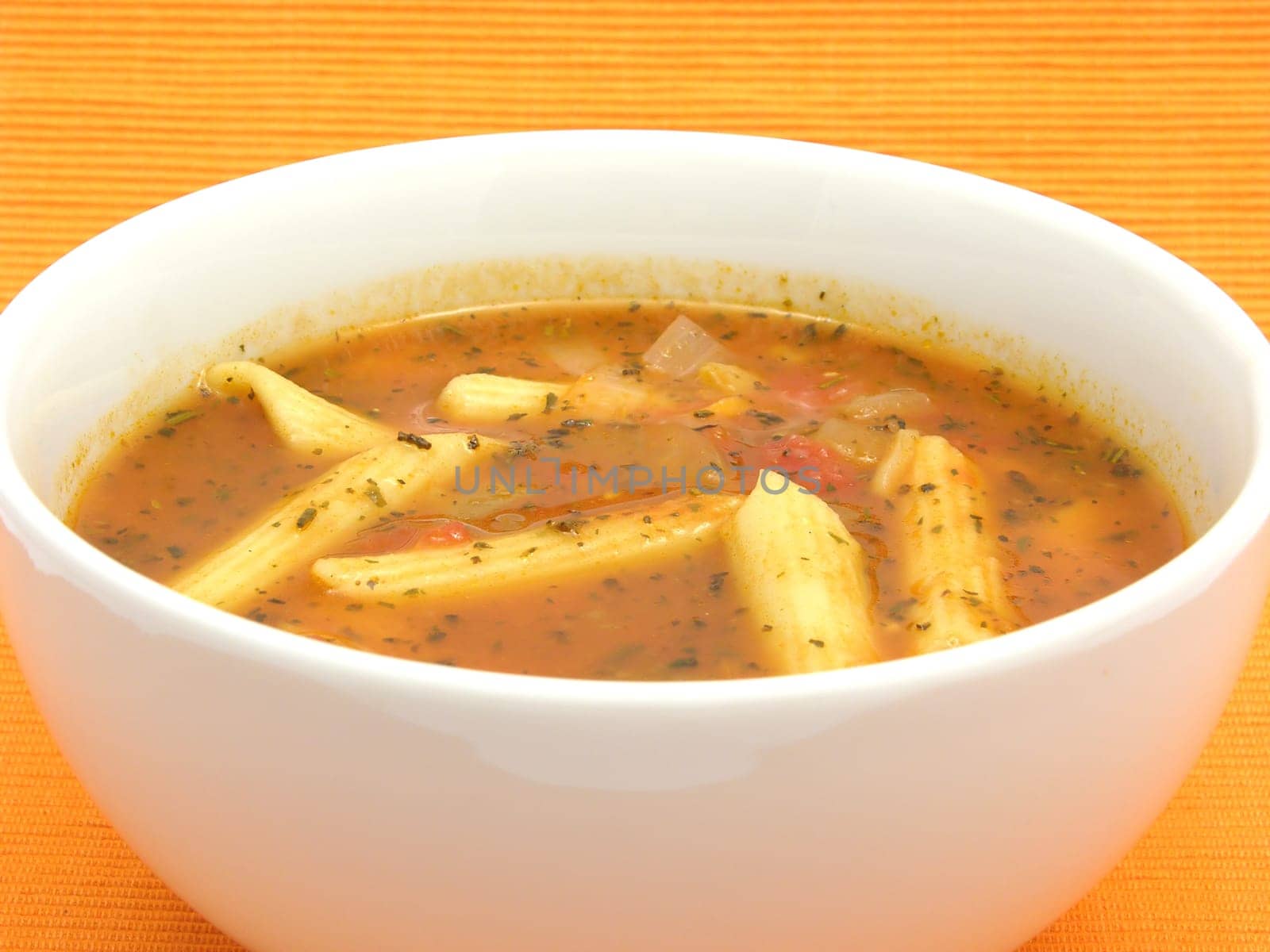 Noodle soup with tomatoes and herbs