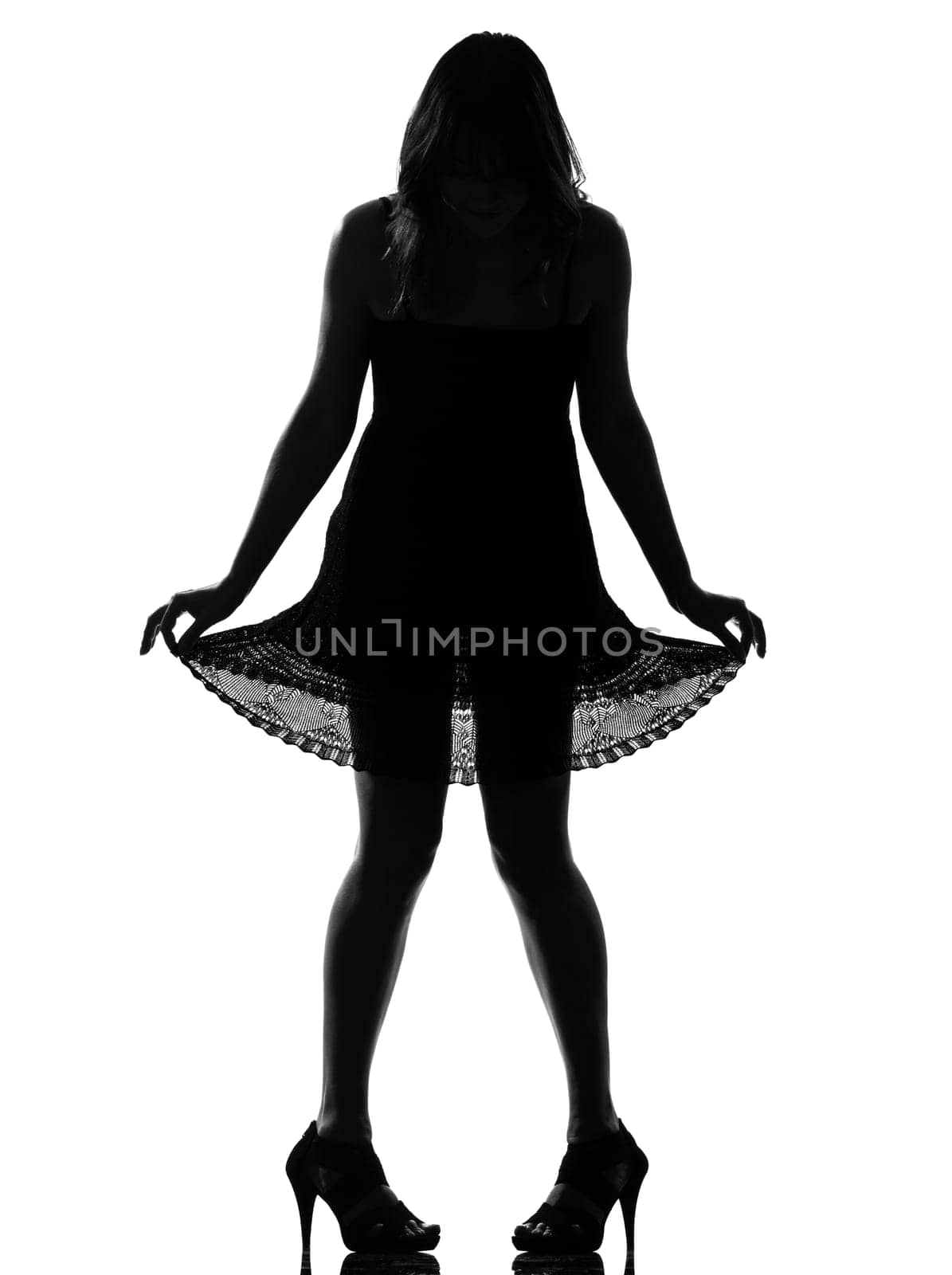 stylish silhouette caucasian beautiful woman showing her legs  full length on studio isolated white background