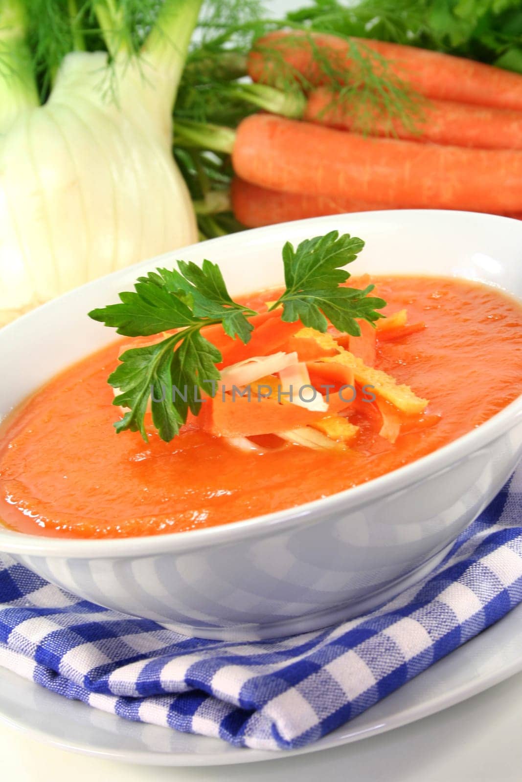 a bowl of carrot soup with fennel and lemon