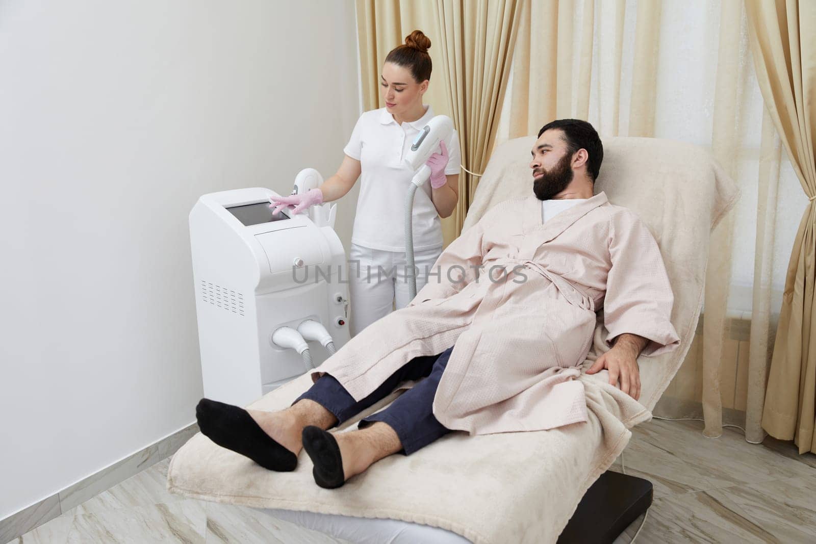 Embracing contemporary grooming, a man experiences laser hair removal on his face in a cosmetology setting