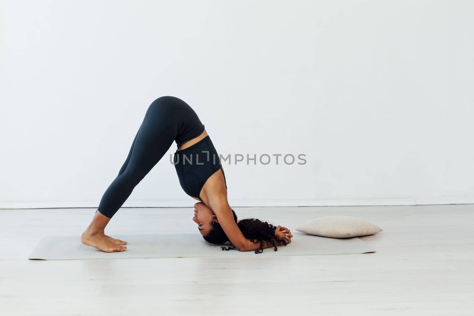 woman doing exercises yoga asana lotus pose workout by Simakov
