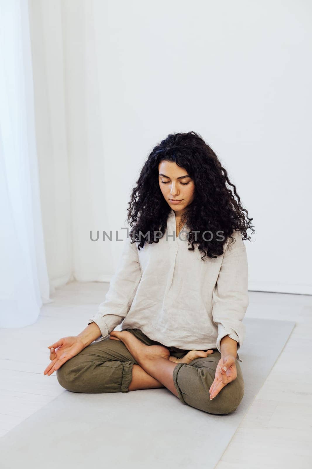 woman doing exercises yoga asana lotus pose workout in the studio