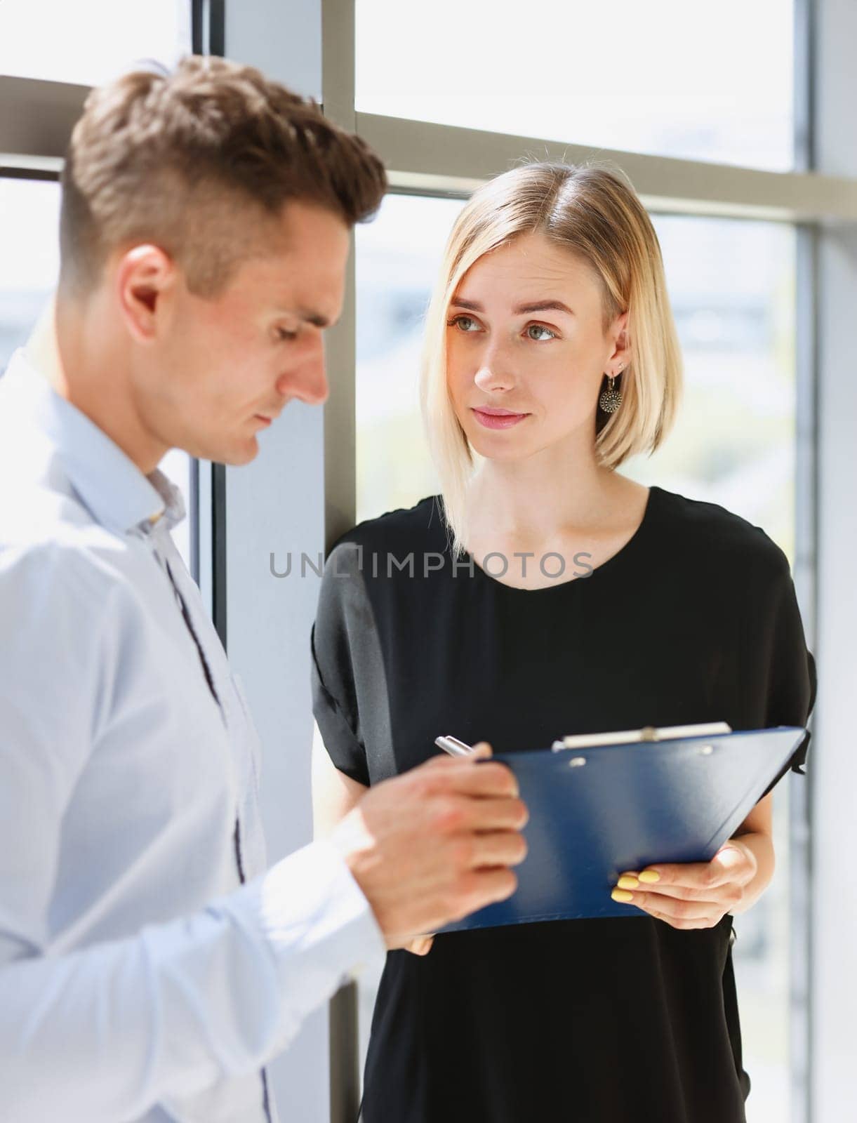 Beautiful woman portrait at workplace examining by kuprevich