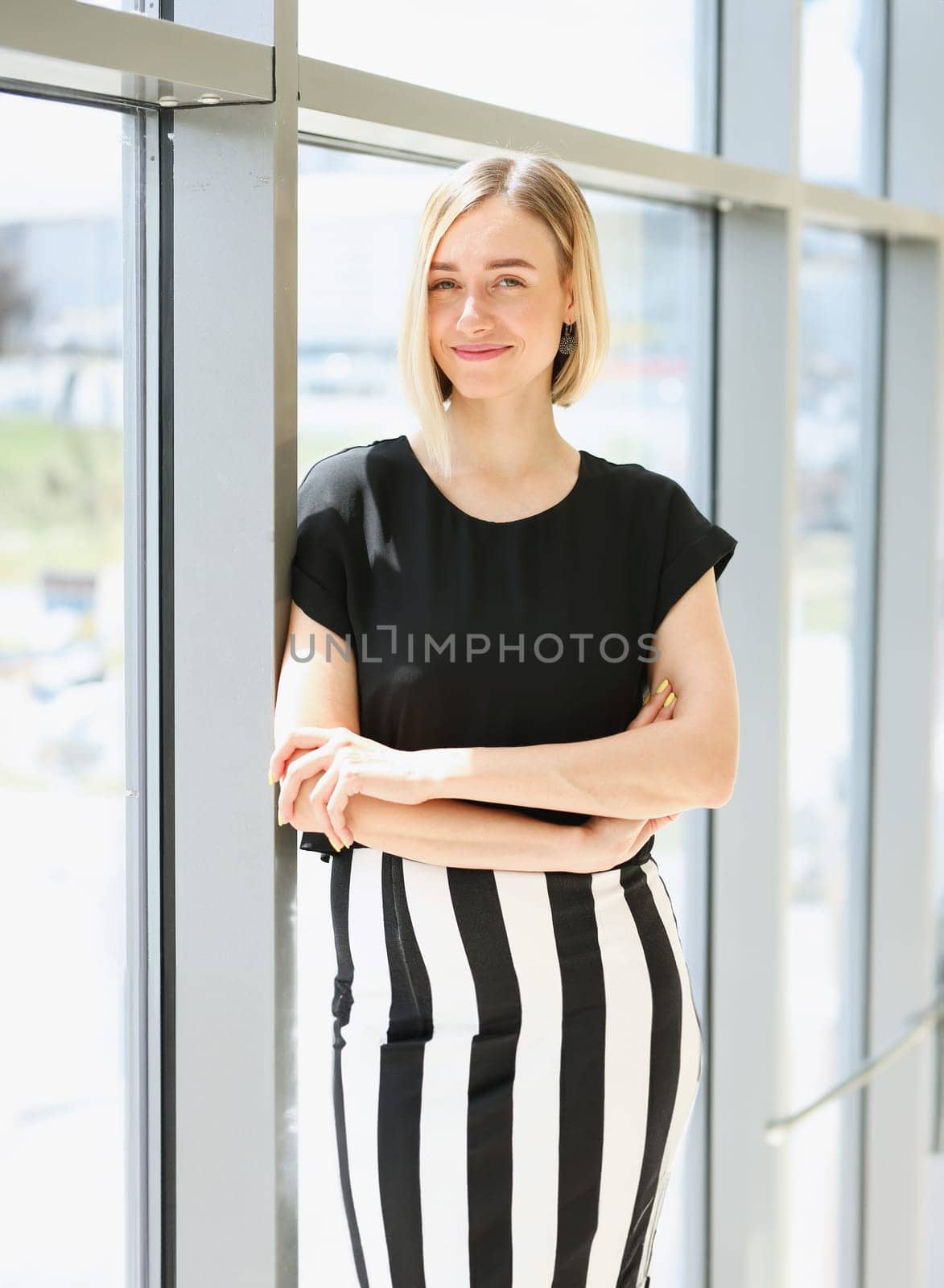 Blonde beauty businesswoman portrait look at camera on window background