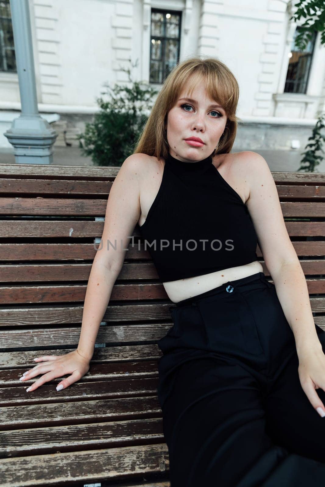 red-haired woman posing at a park bench for a walk