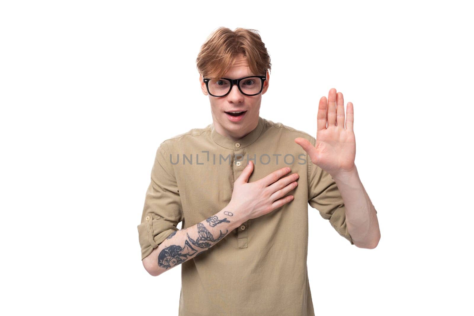 young handsome caucasian guy with red hair in a brown shirt.