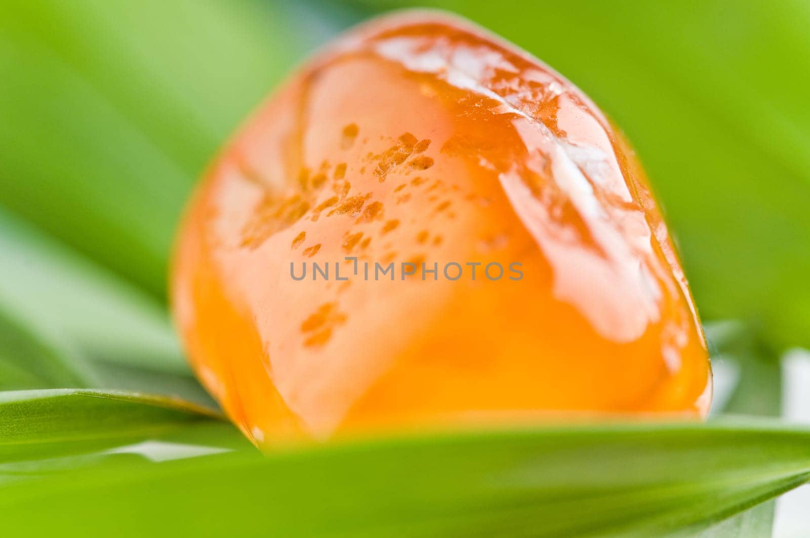 Natural stone carnelian shines in beautiful colors on a white background