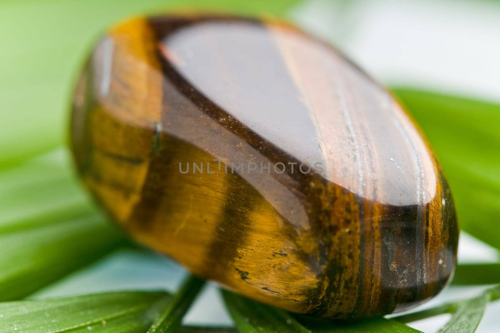 Natural stone tiger iron,shines in beautiful colors on a white background