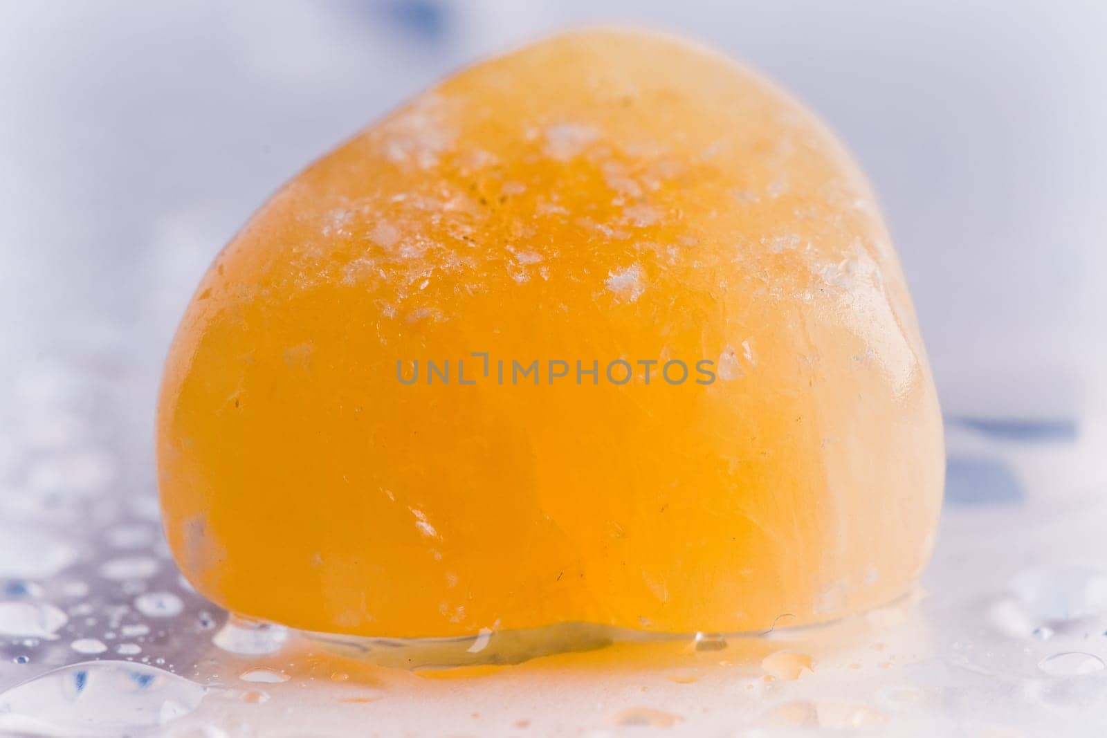 Natural stone carnelian shines in beautiful colors on a white background