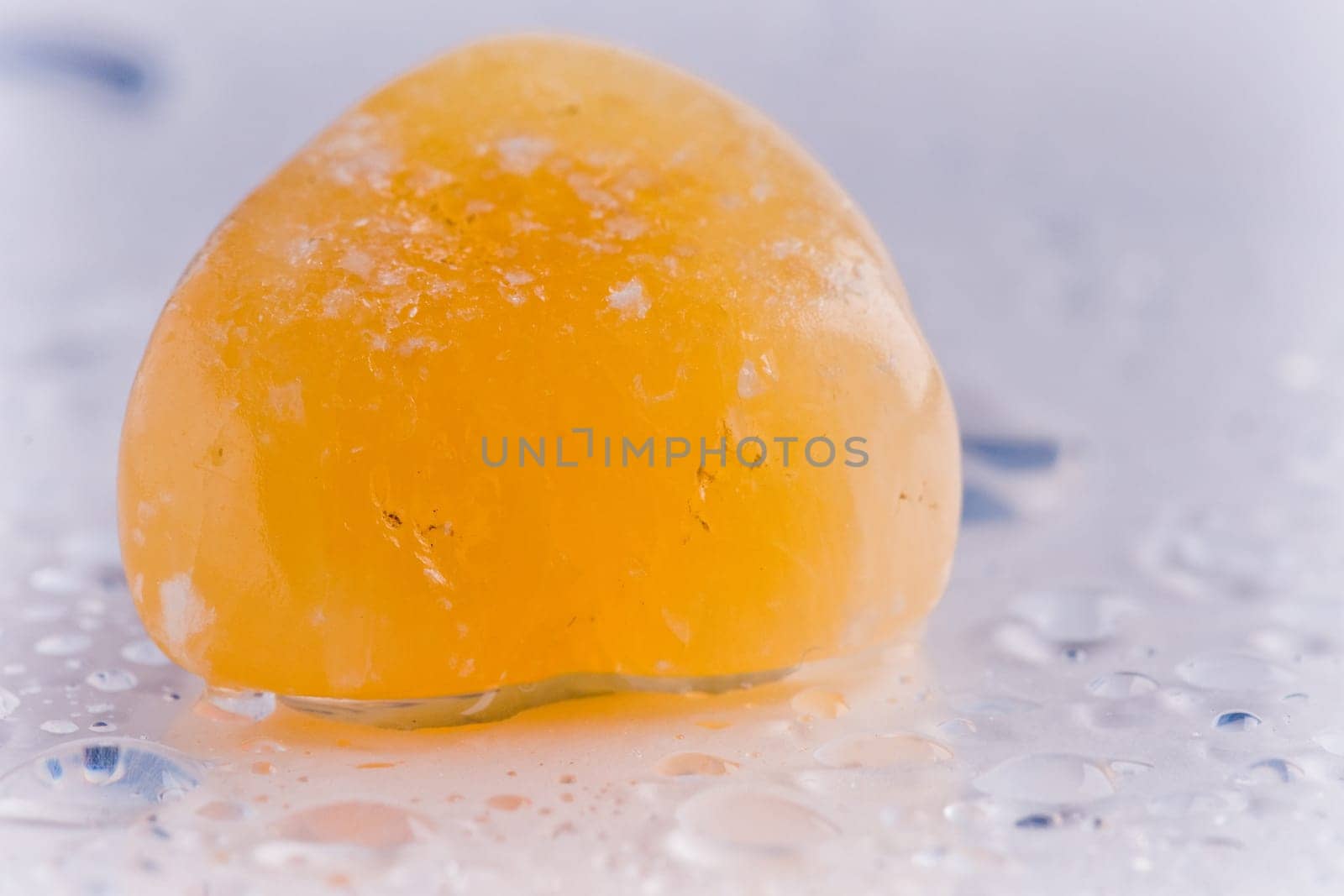 Natural stone carnelian shines in beautiful colors on a white background