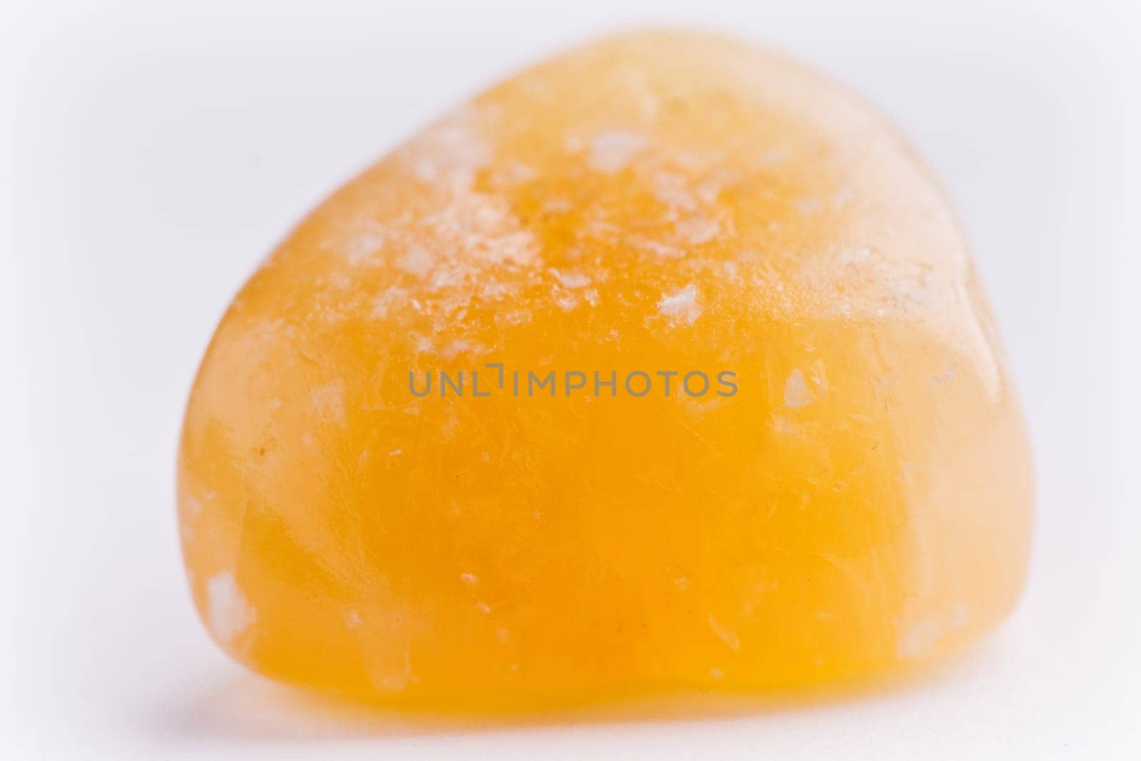 Natural stone carnelian shines in beautiful colors on a white background