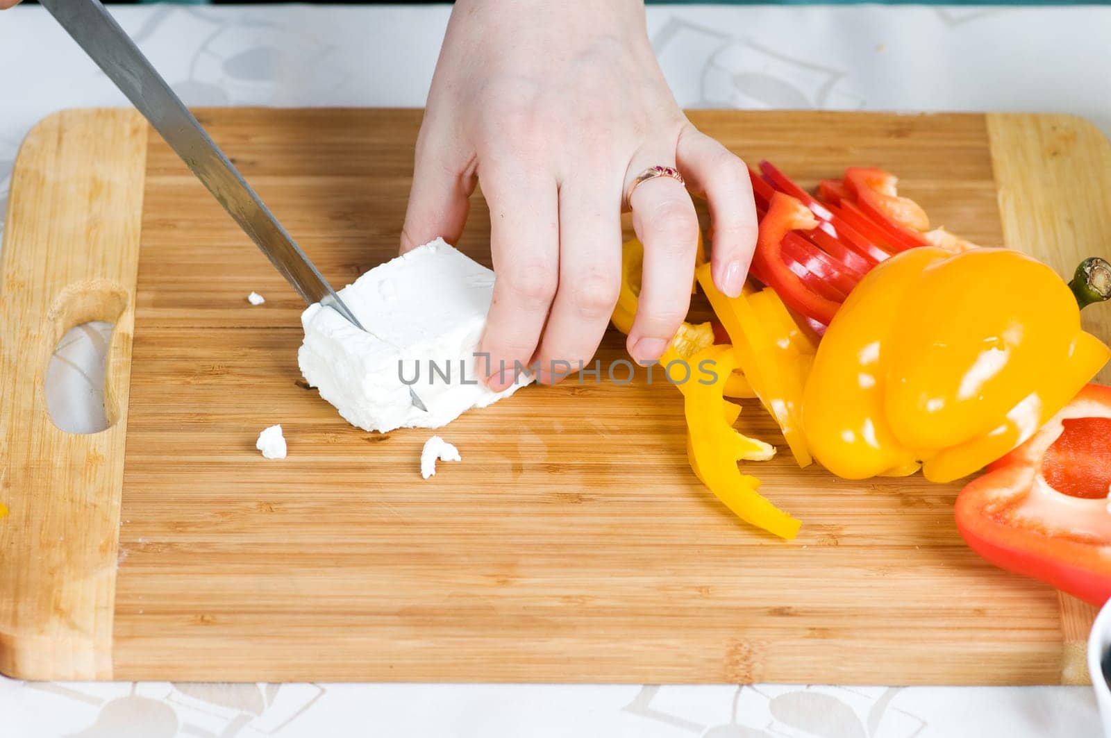 Preparation of salad from cheese and fresh vegetables