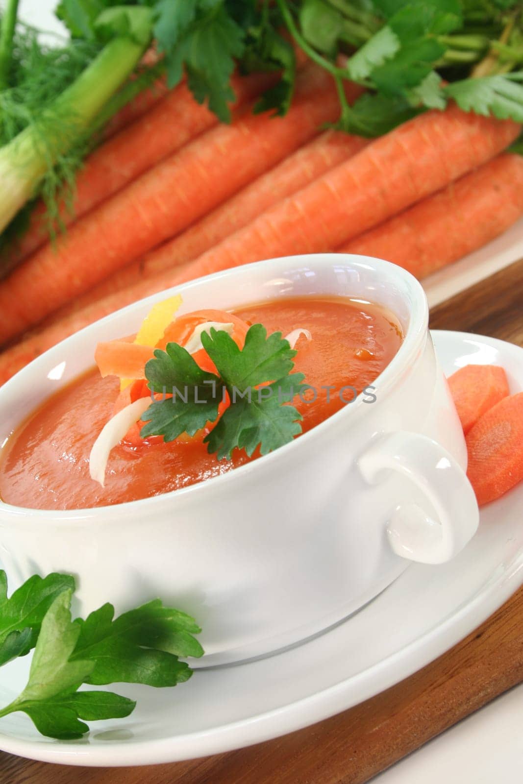 a bowl of carrot soup with fennel and lemon