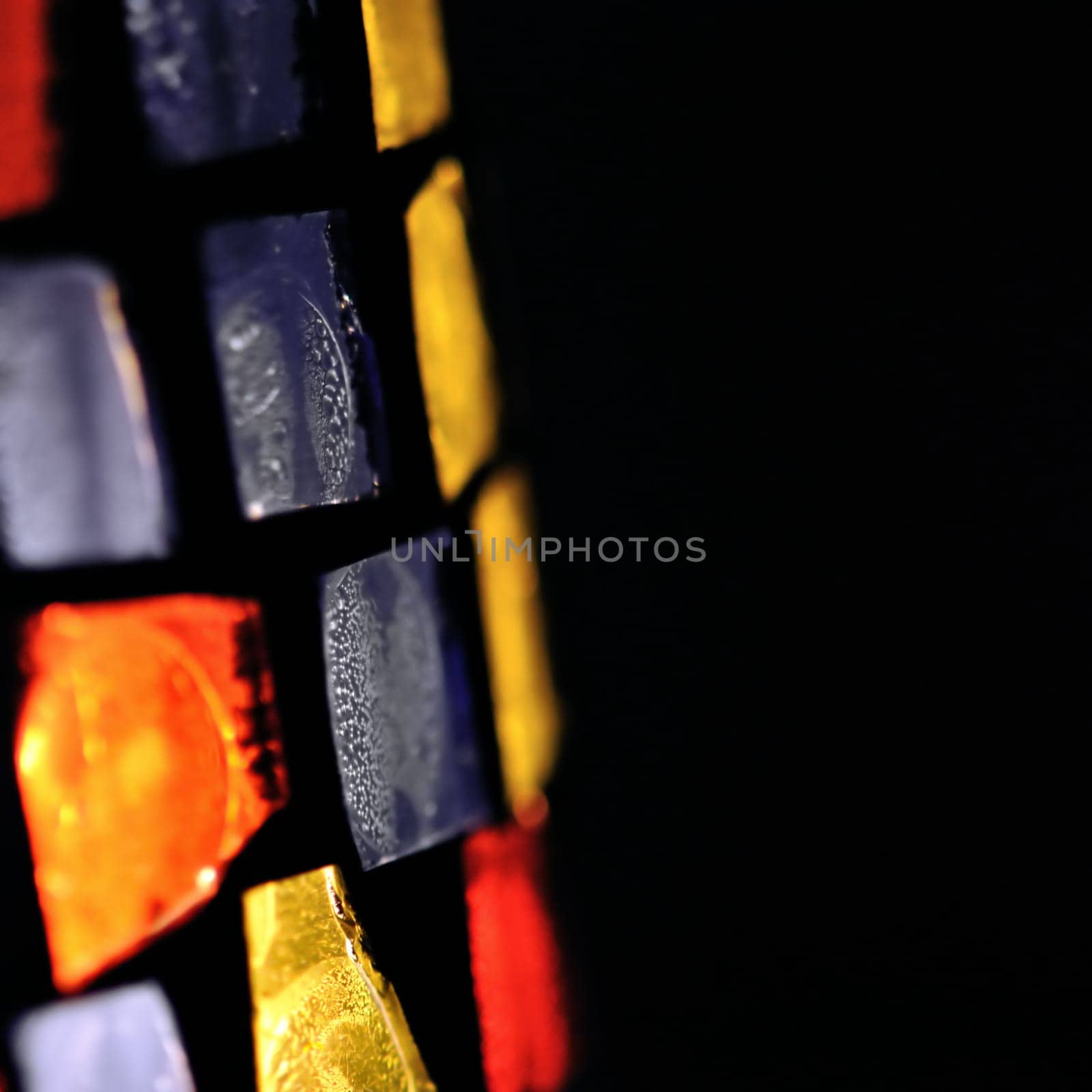 Colorful stained glass abstract shapes background. Selective focus.