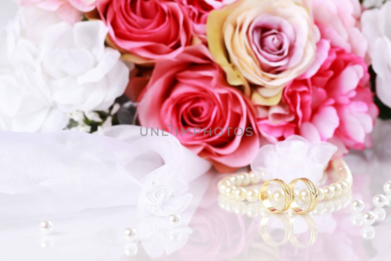 Wedding still life with beautiful golden rings and bouquet