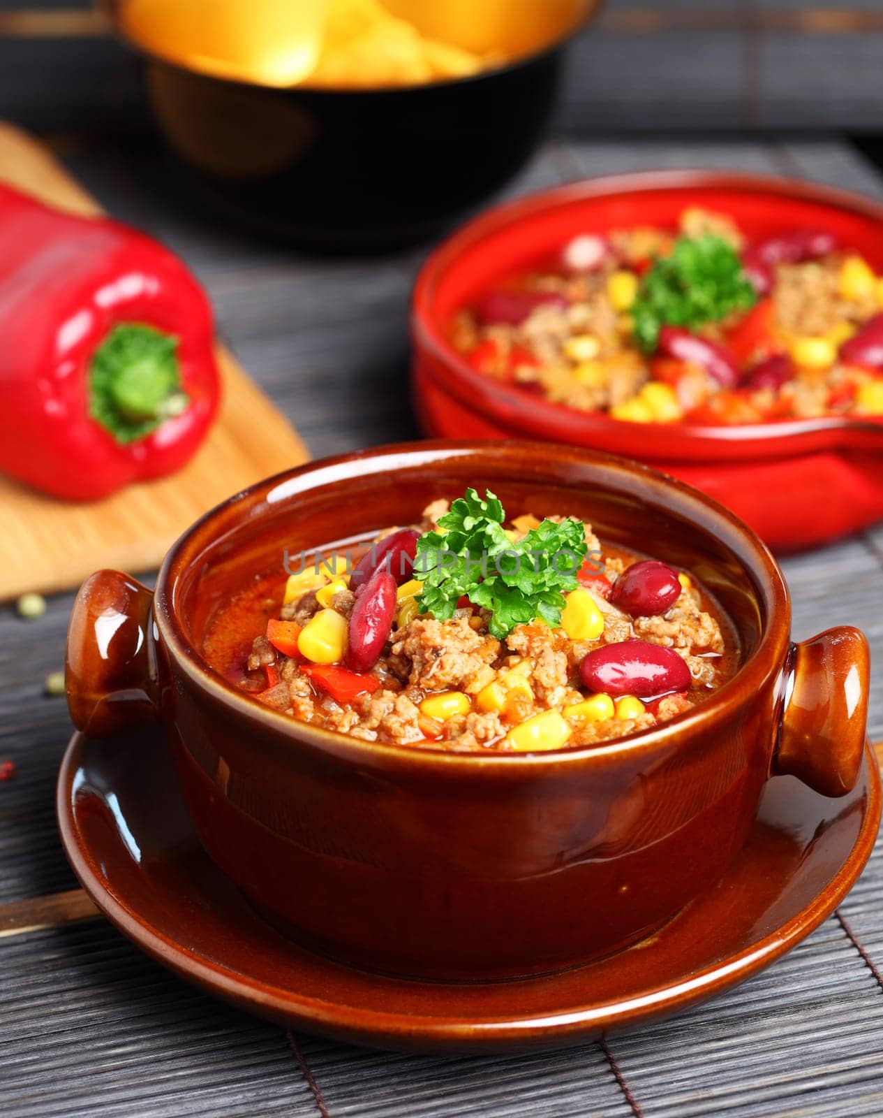 Bowl of chili with peppers and beans