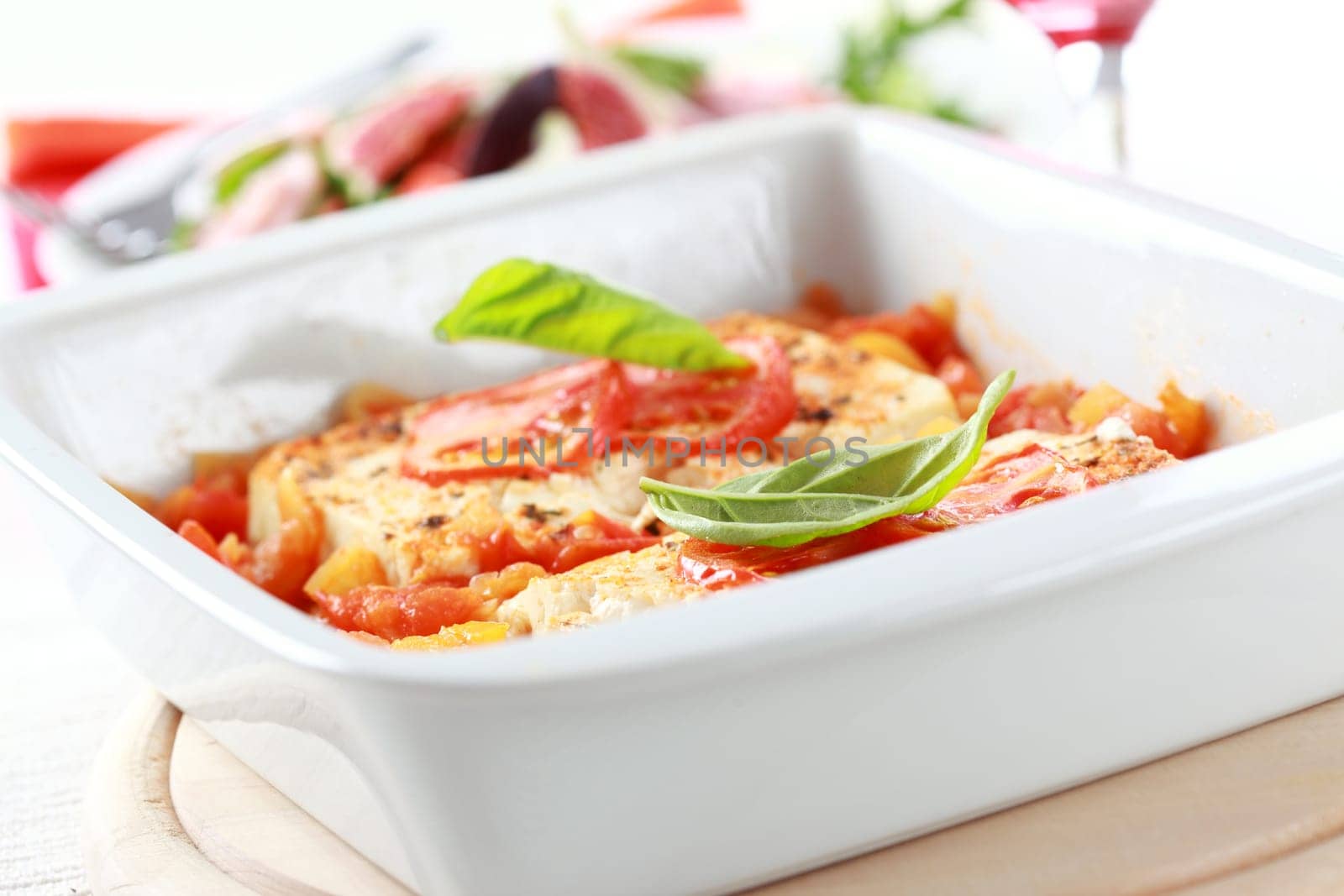 Baked feta cheese with hot salsa sauce with salad