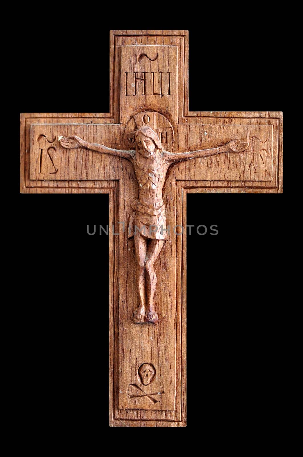 Wooden crucifix with skull and crossbones isolated on black background.