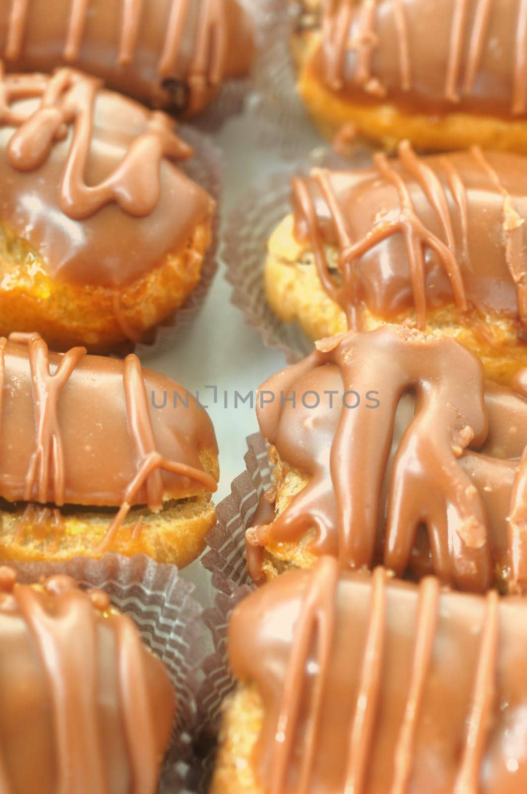 Eclair dessert covered with chocolate icing. Selective focus.