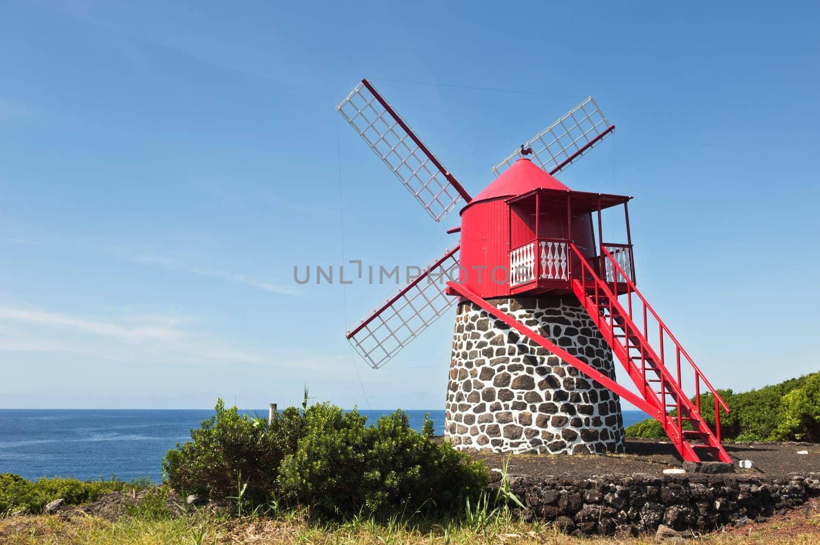 Red windmill in the coast of Pico island, Azores