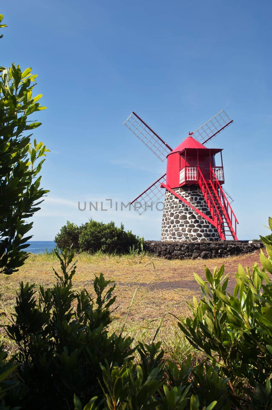 Red windmill in the coast of Pico island, Azores