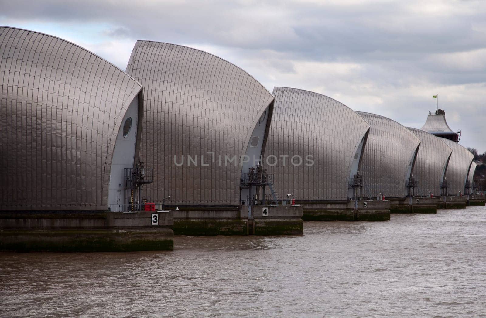 Thames barrier surrounded by dark clouds