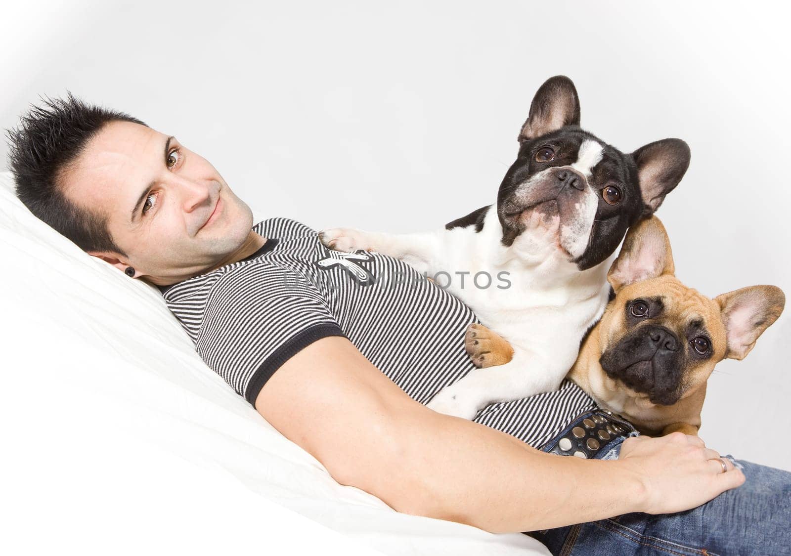 a young handsome man with a small french bulldog