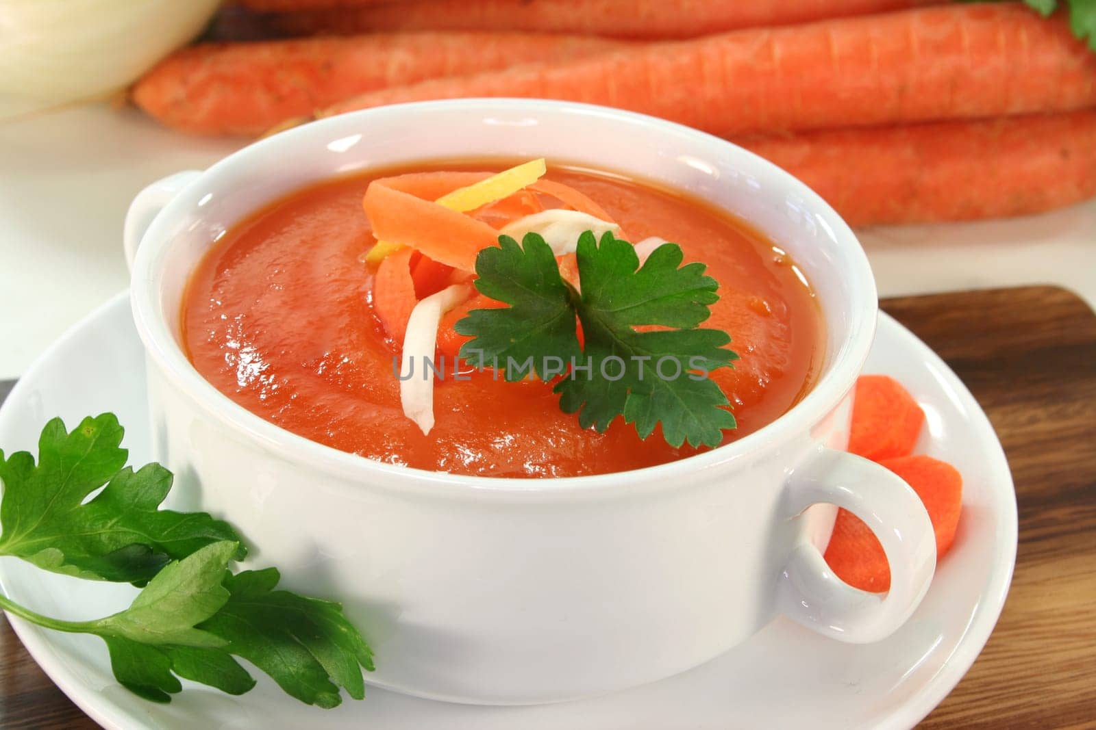 a bowl of carrot soup with fennel and lemon