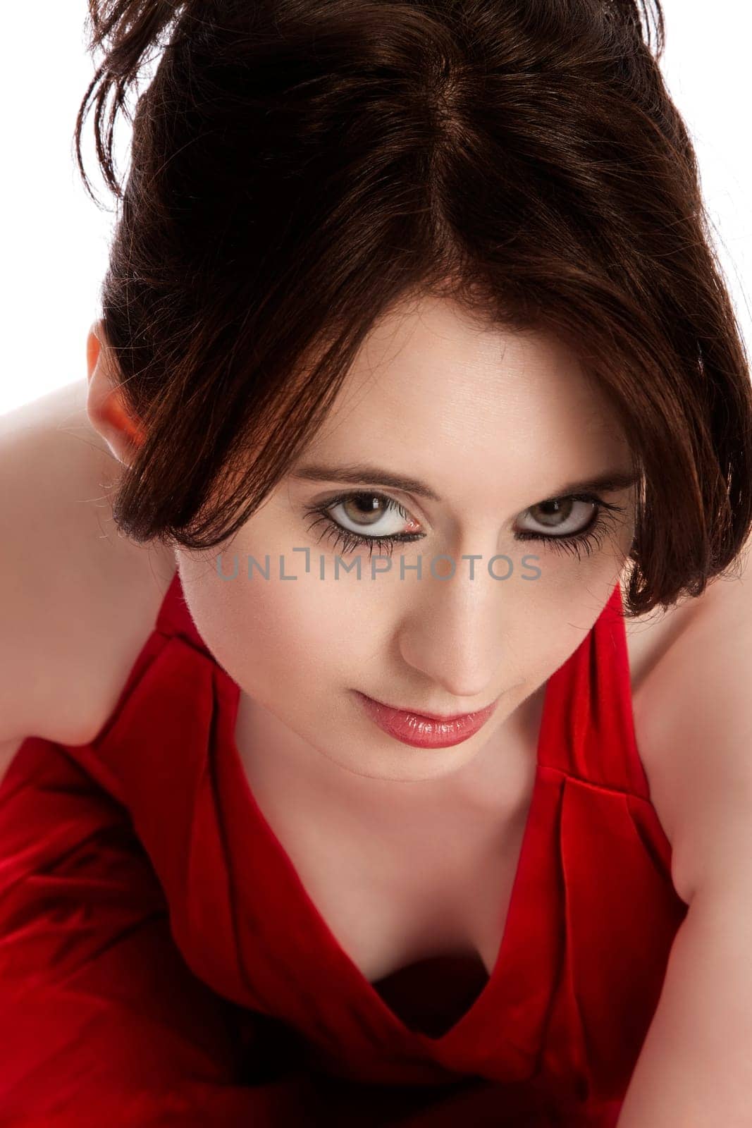 Portrait of a young pretty woman in a red evening dress