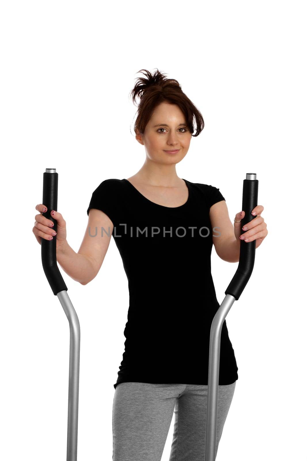 Young pretty woman exercising on a stepper