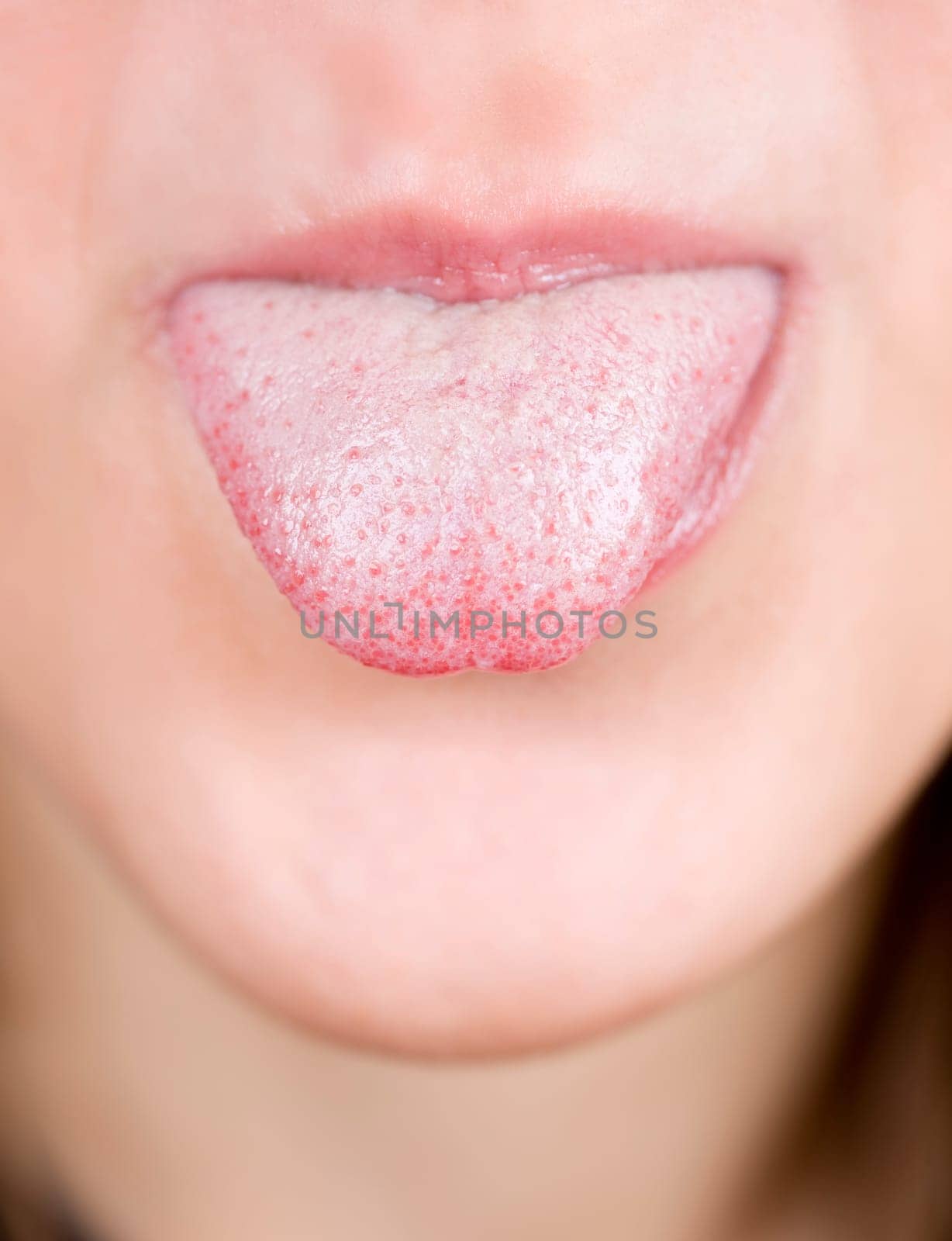 a young pretty girl showing her thongue as a joke