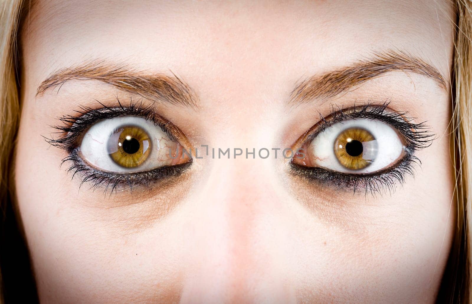 close up of the eyes of a pretty young girl in a surprise or fear expression