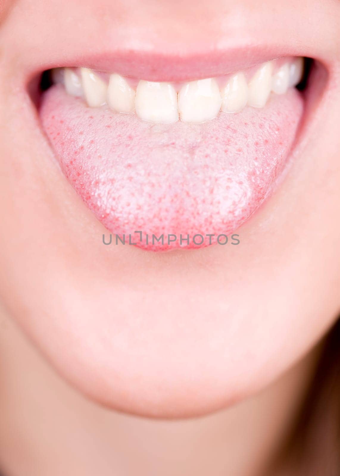 a young pretty girl showing her thongue as a joke