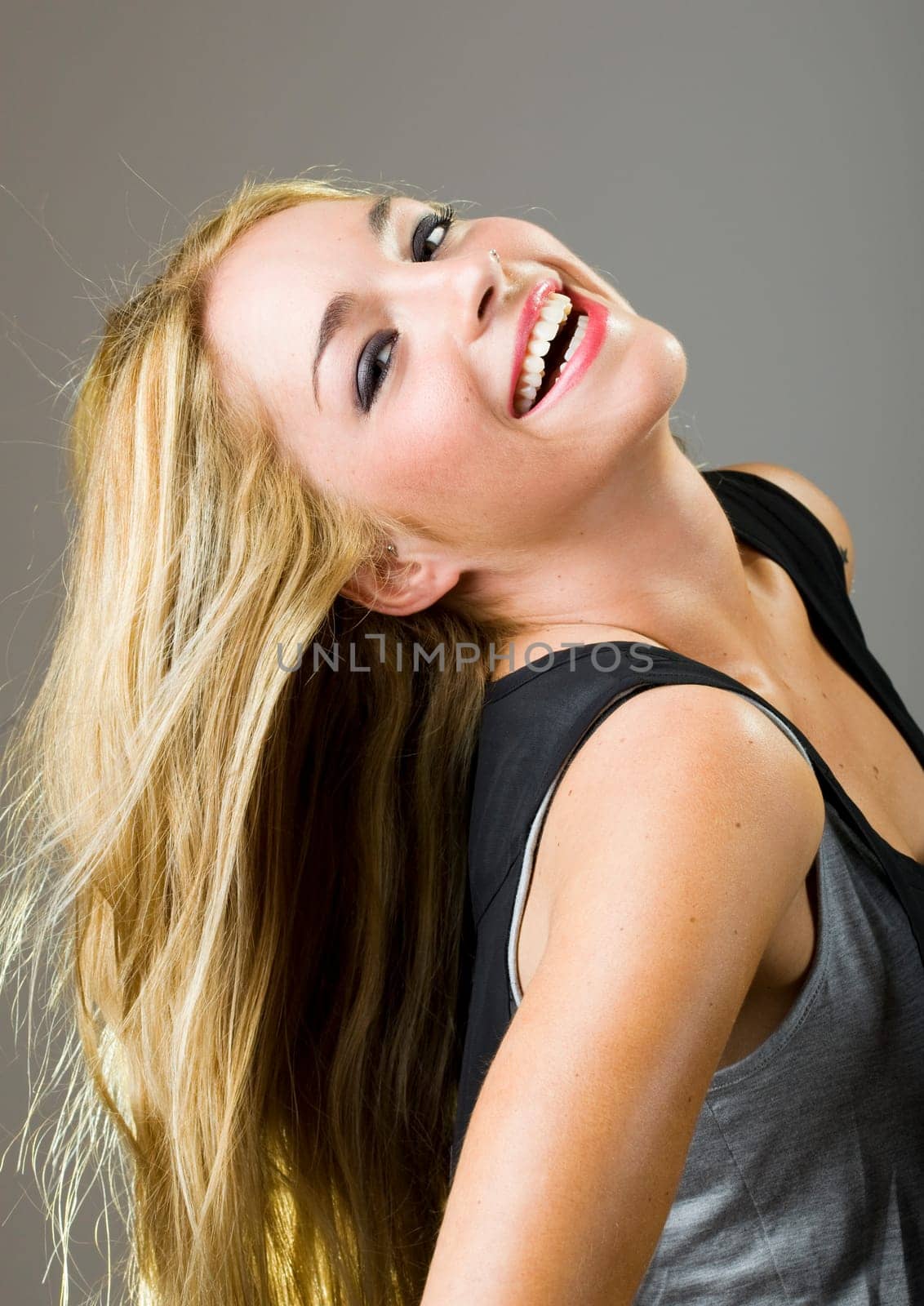 a beautiful blonde girl smiling and showing perfect teeth