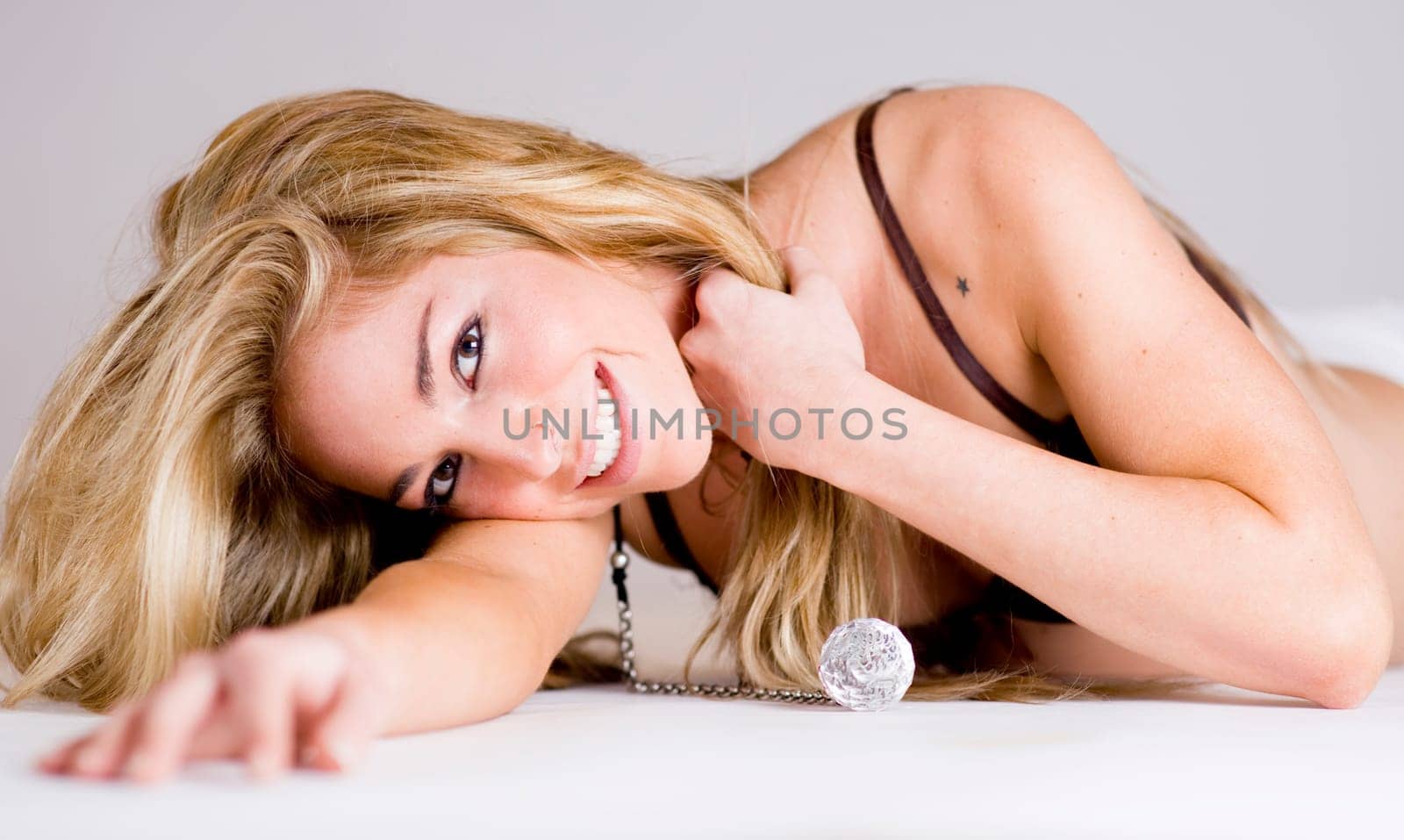 a beautiful blonde girl smiling and showing perfect teeth