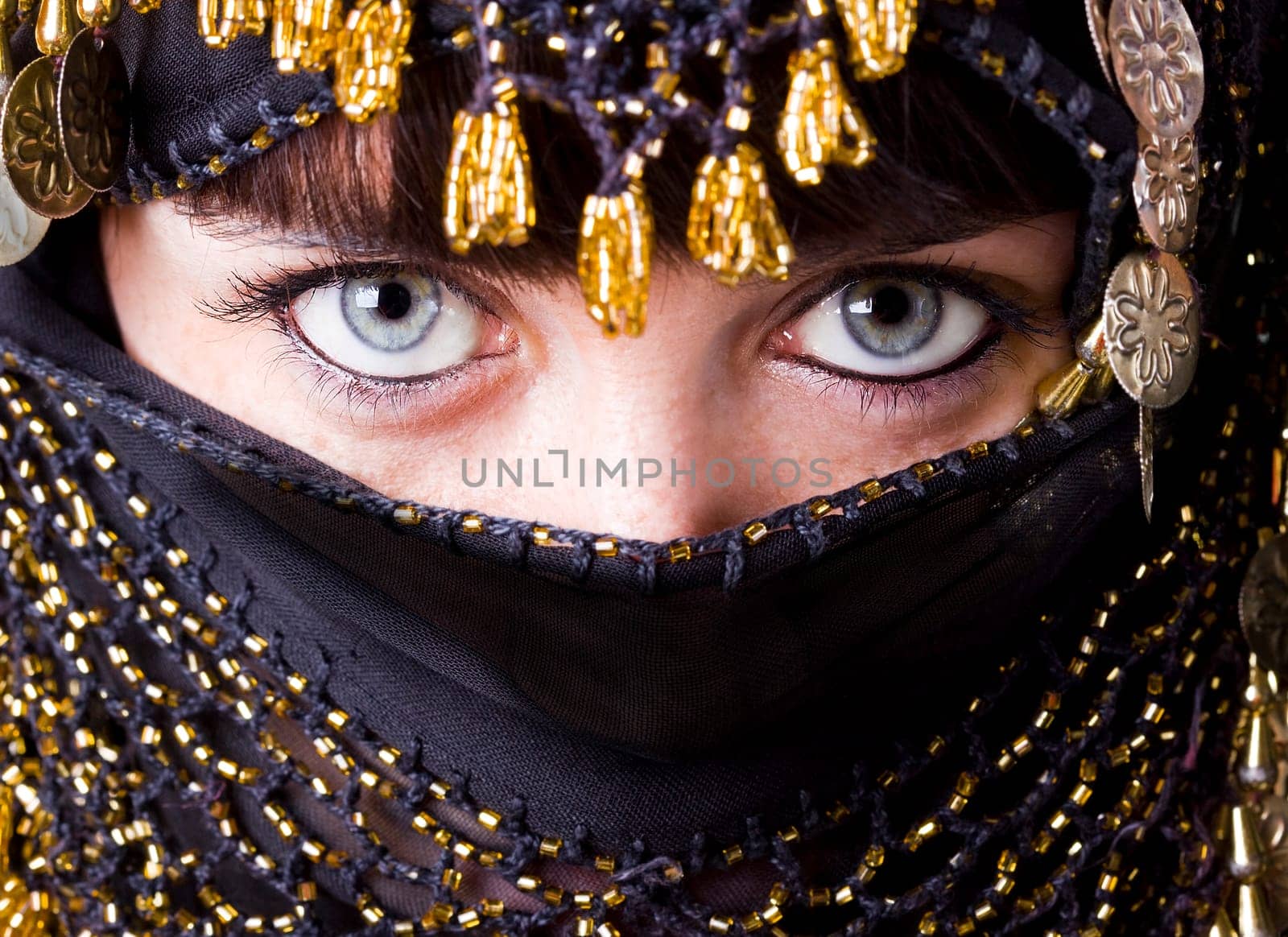 woman with beautiful blue eyes behind an arabic veil