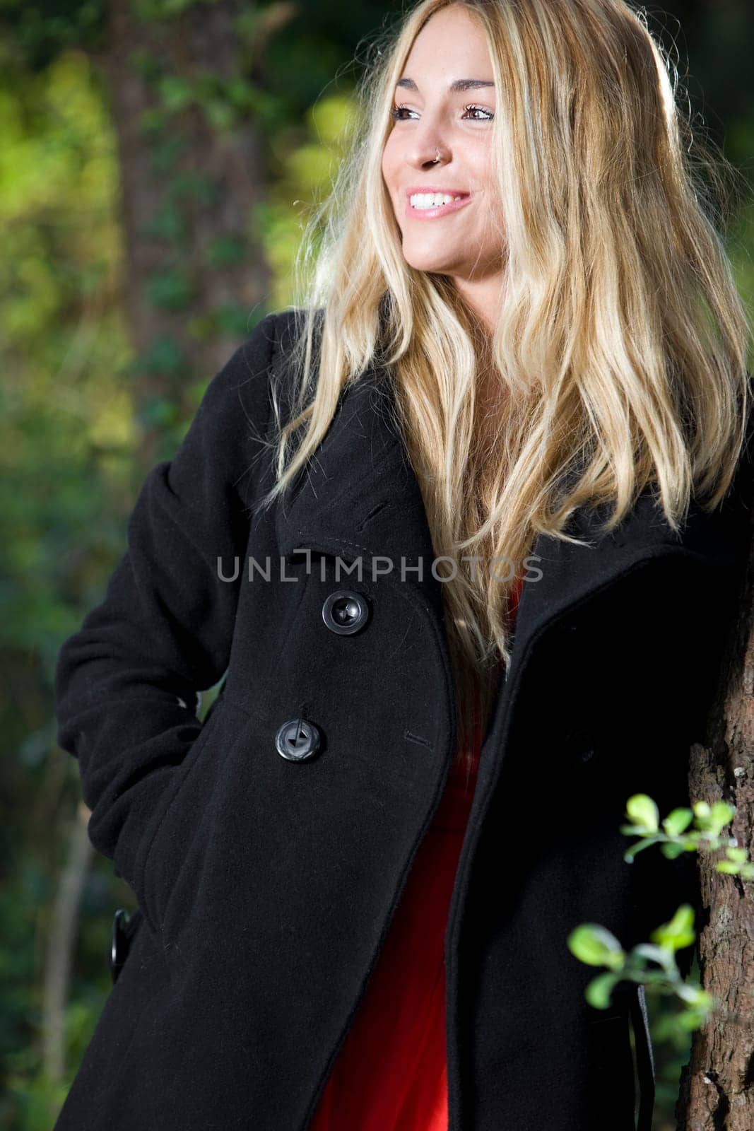 beautiful young girl with a red dress in the nature