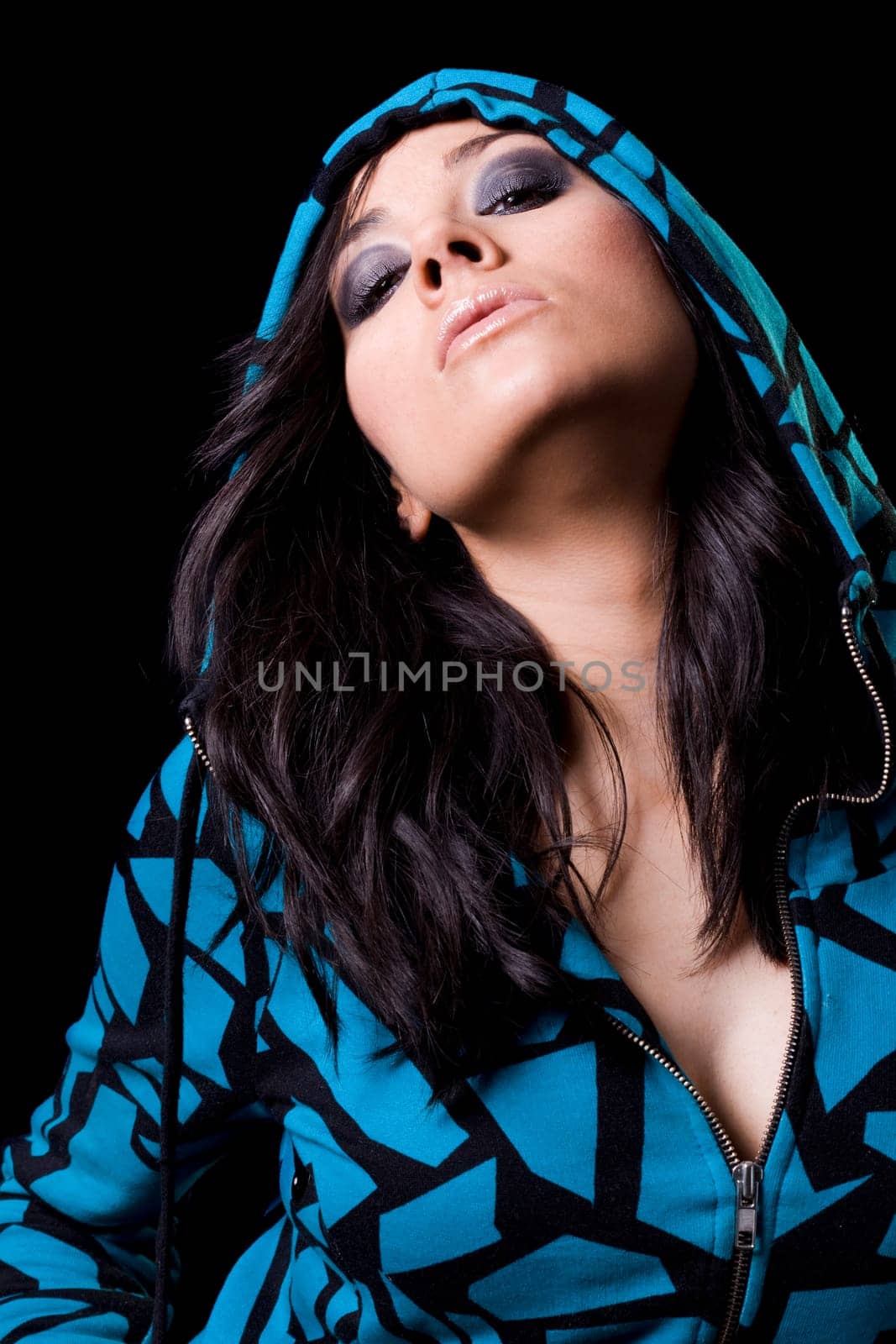 beautiful brunete girl in an aggressive attitude with a dark background