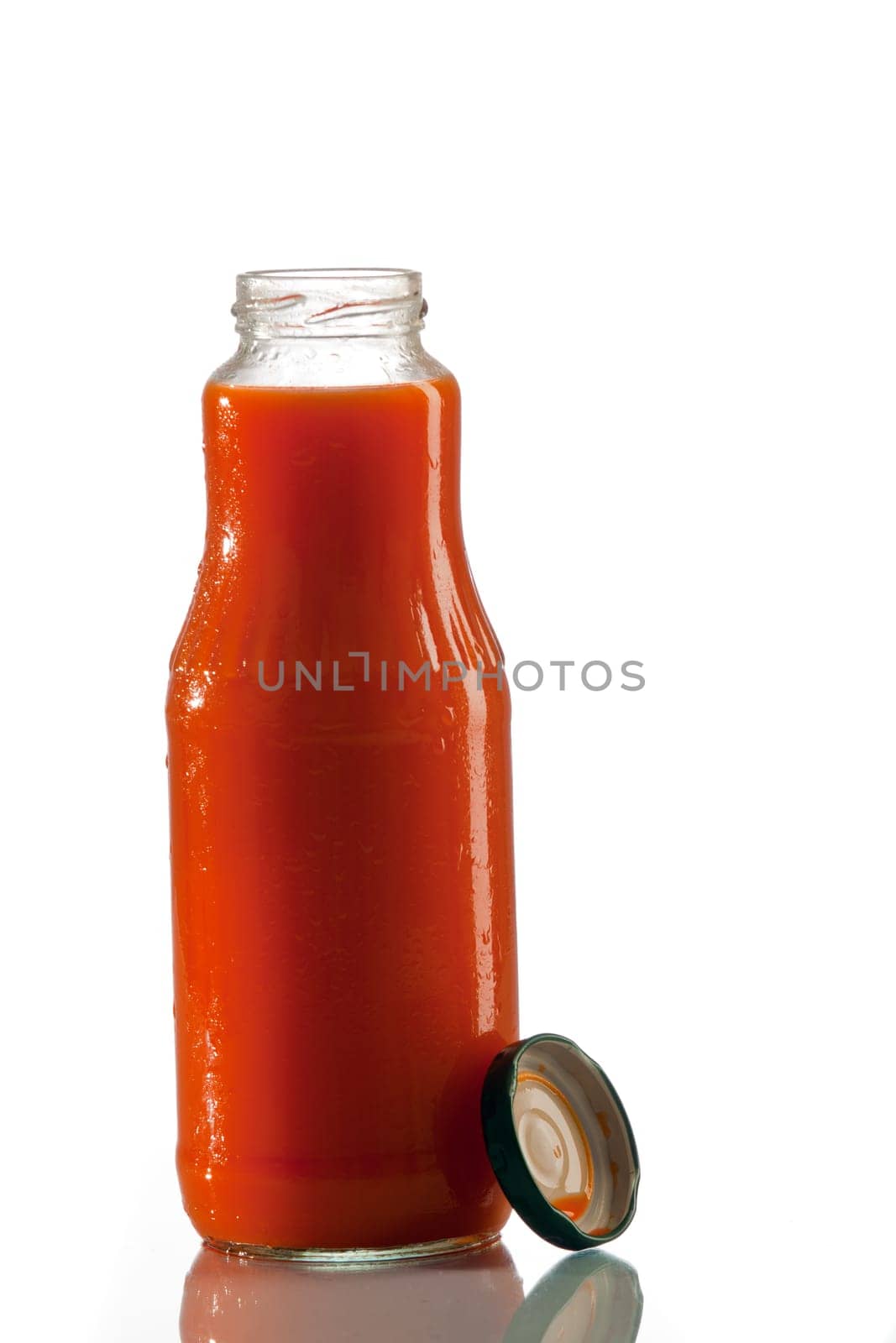 Tomato juice in a glass bottle