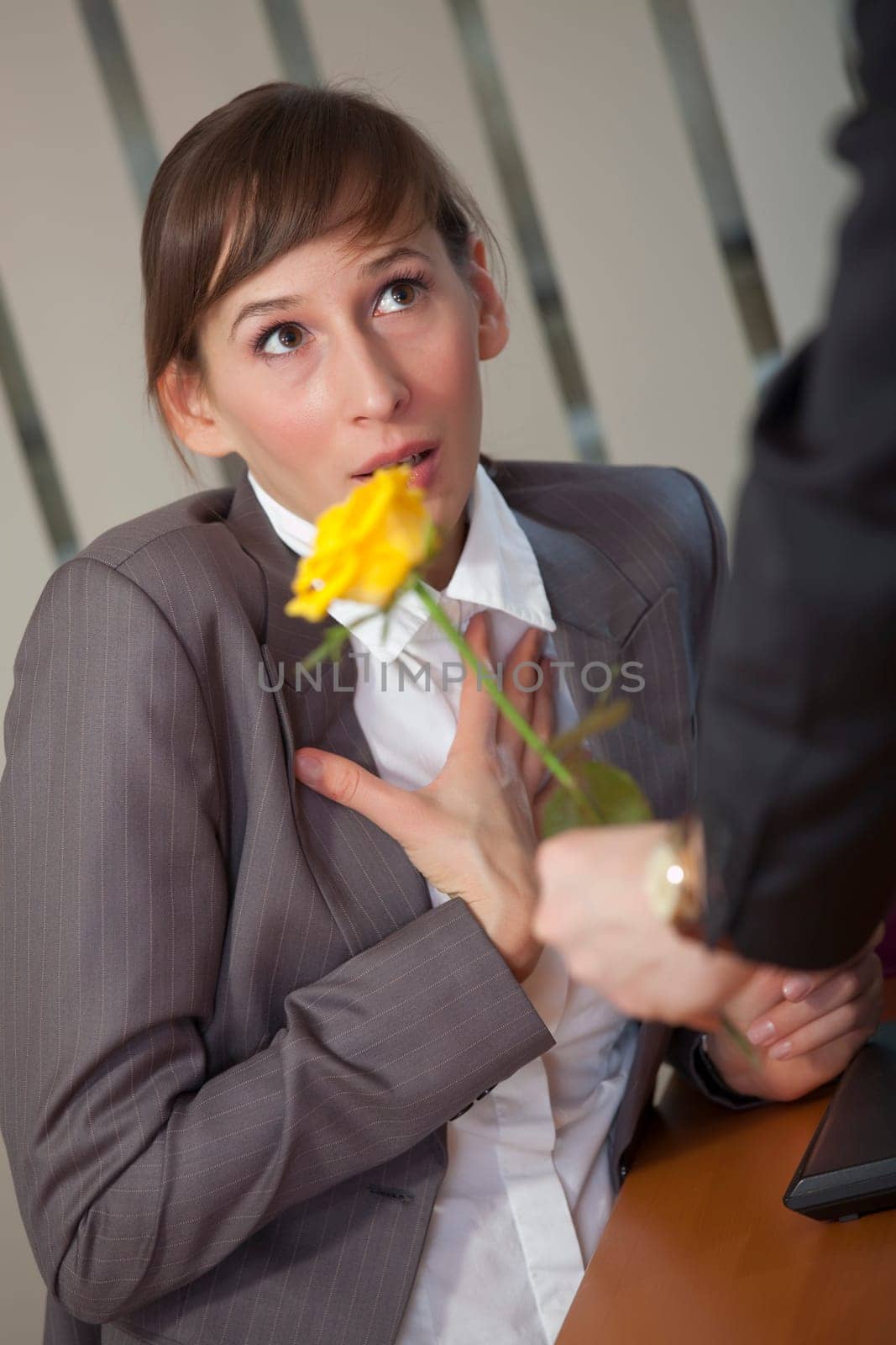 Man giving rose as a gift to a female office worker