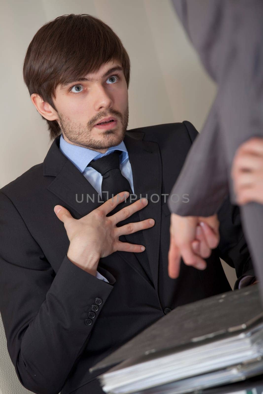 angry boss giving lots of paperwork to his assistant
