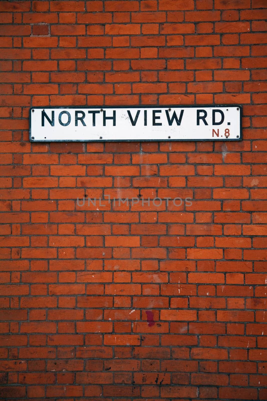 Street sign on an English brick wall