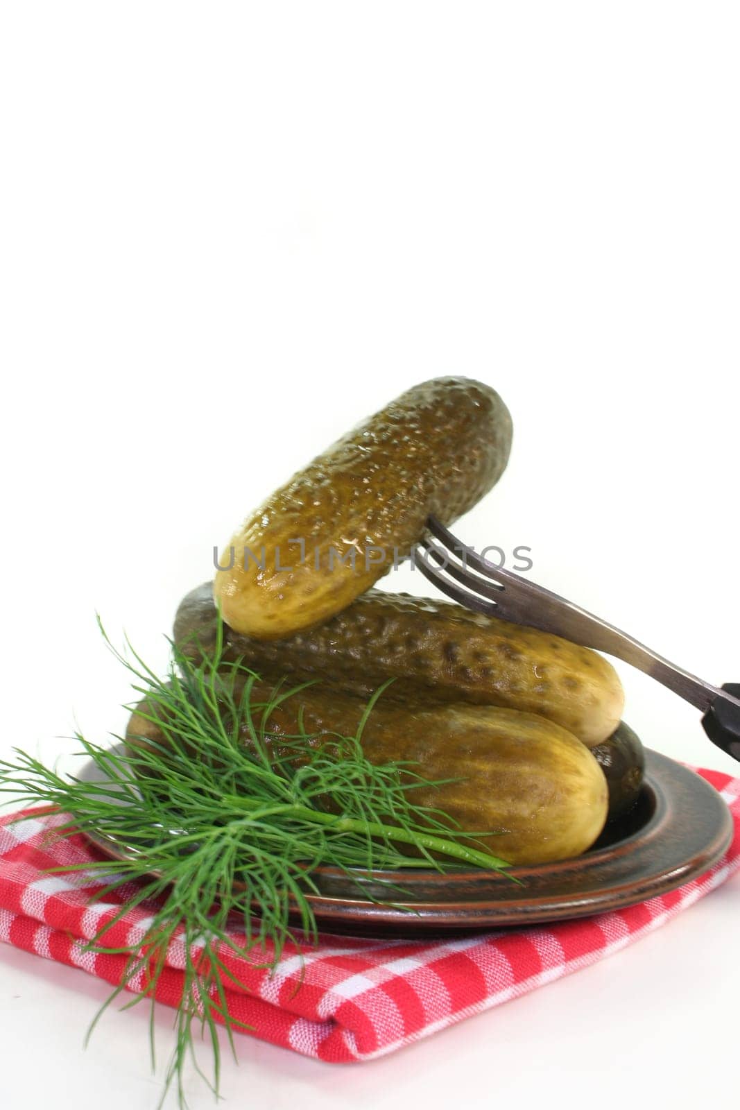 Pickles and dill on a plate