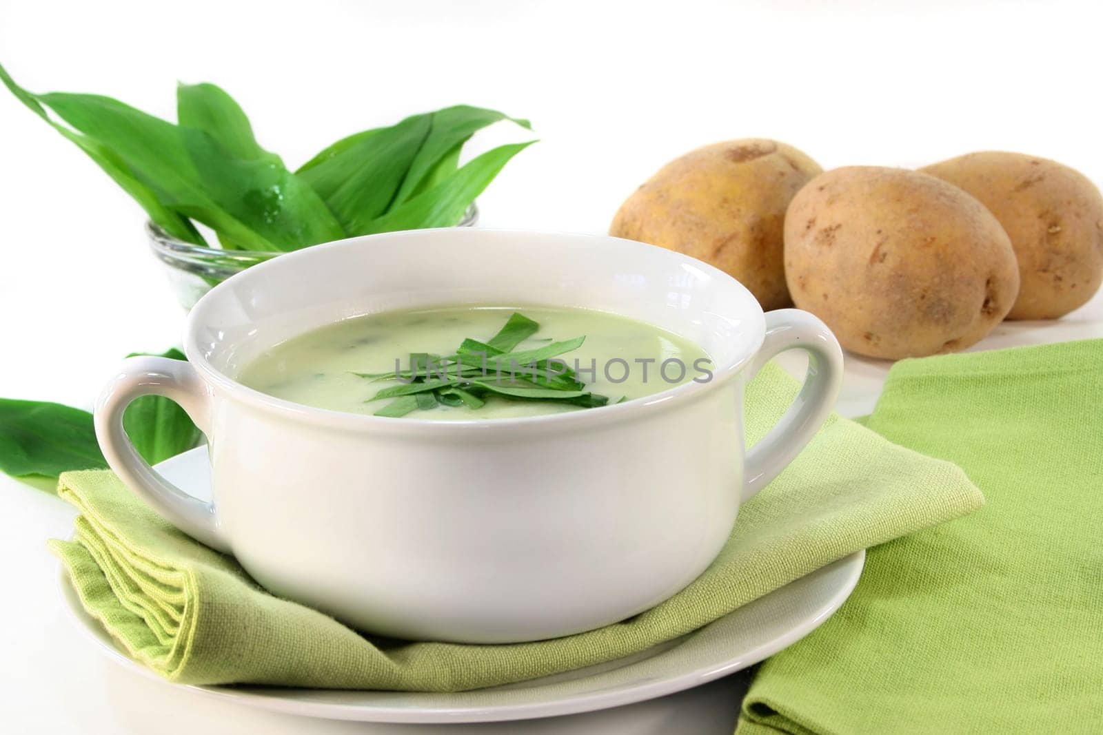 a cup of wild garlic soup with fresh wild garlic