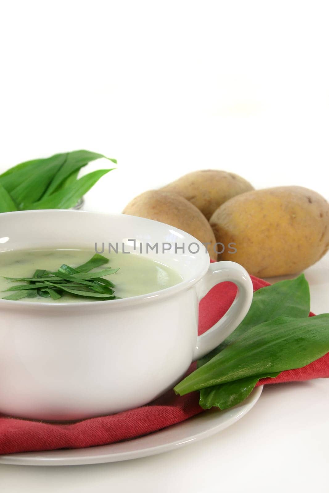 a cup of wild garlic soup with fresh wild garlic