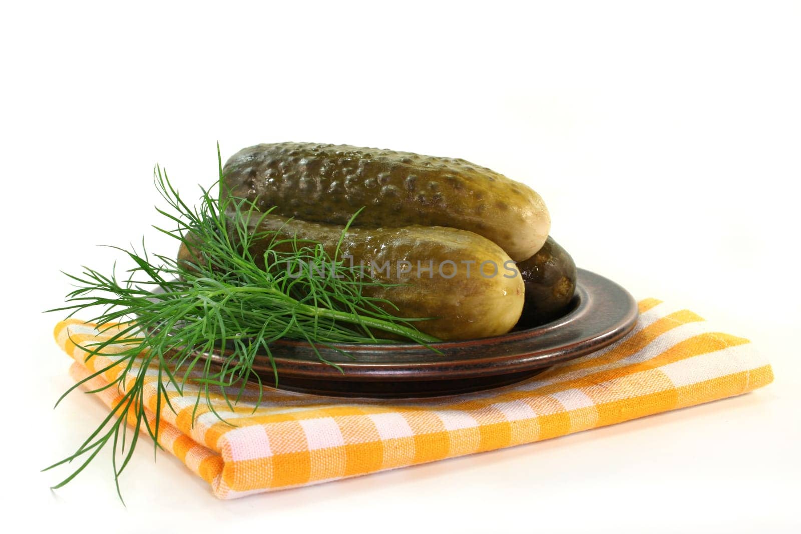 Pickles and dill on a plate