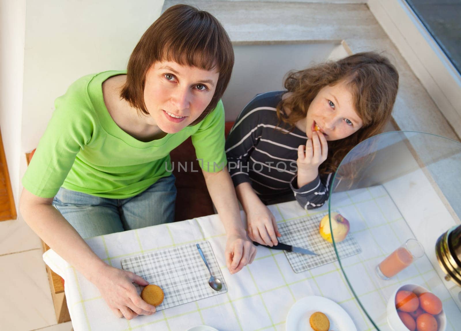 Daughter and her mom having a breakfast together. High angle view.