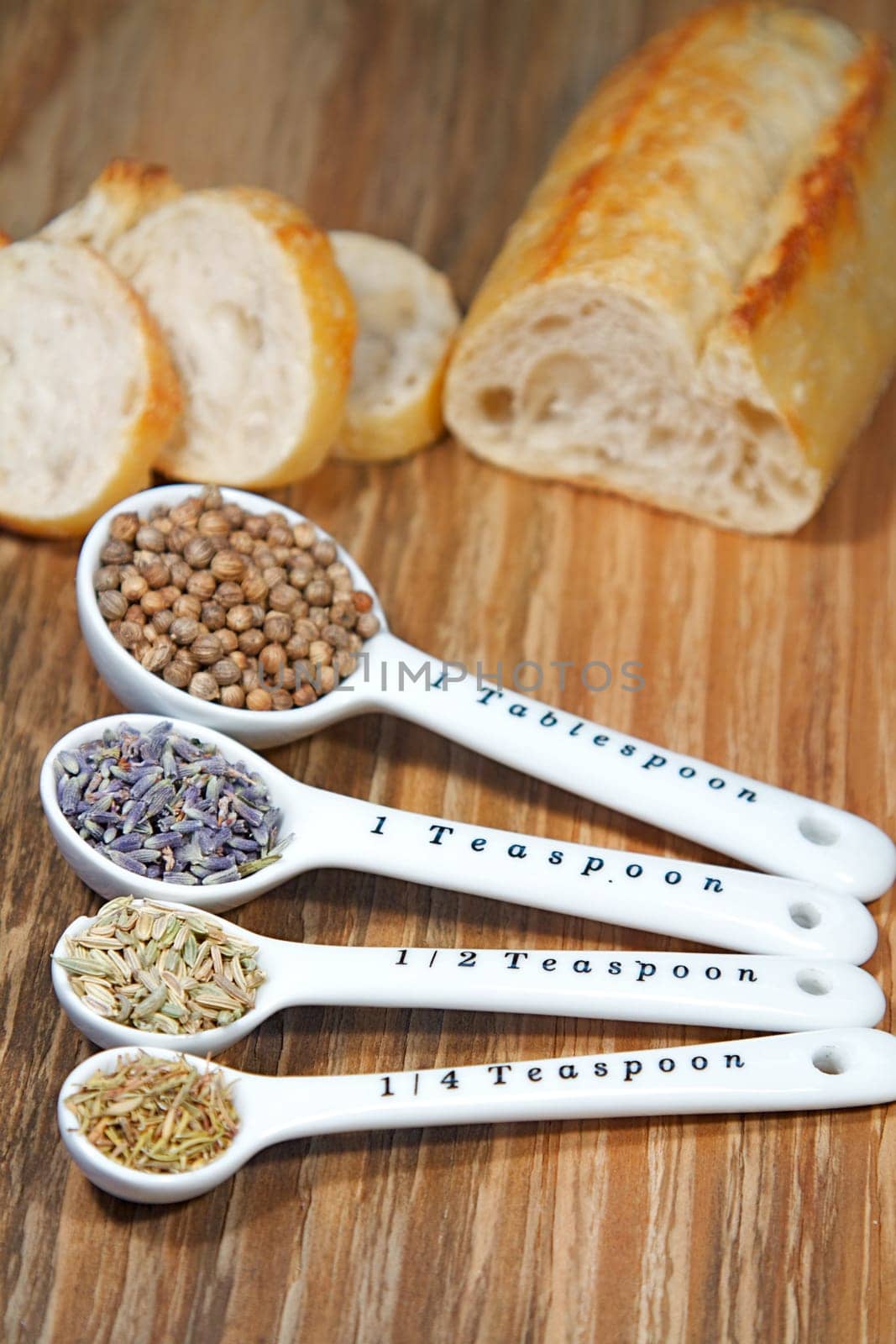 Old table-top selection of herbs and grains in measuring spoons
