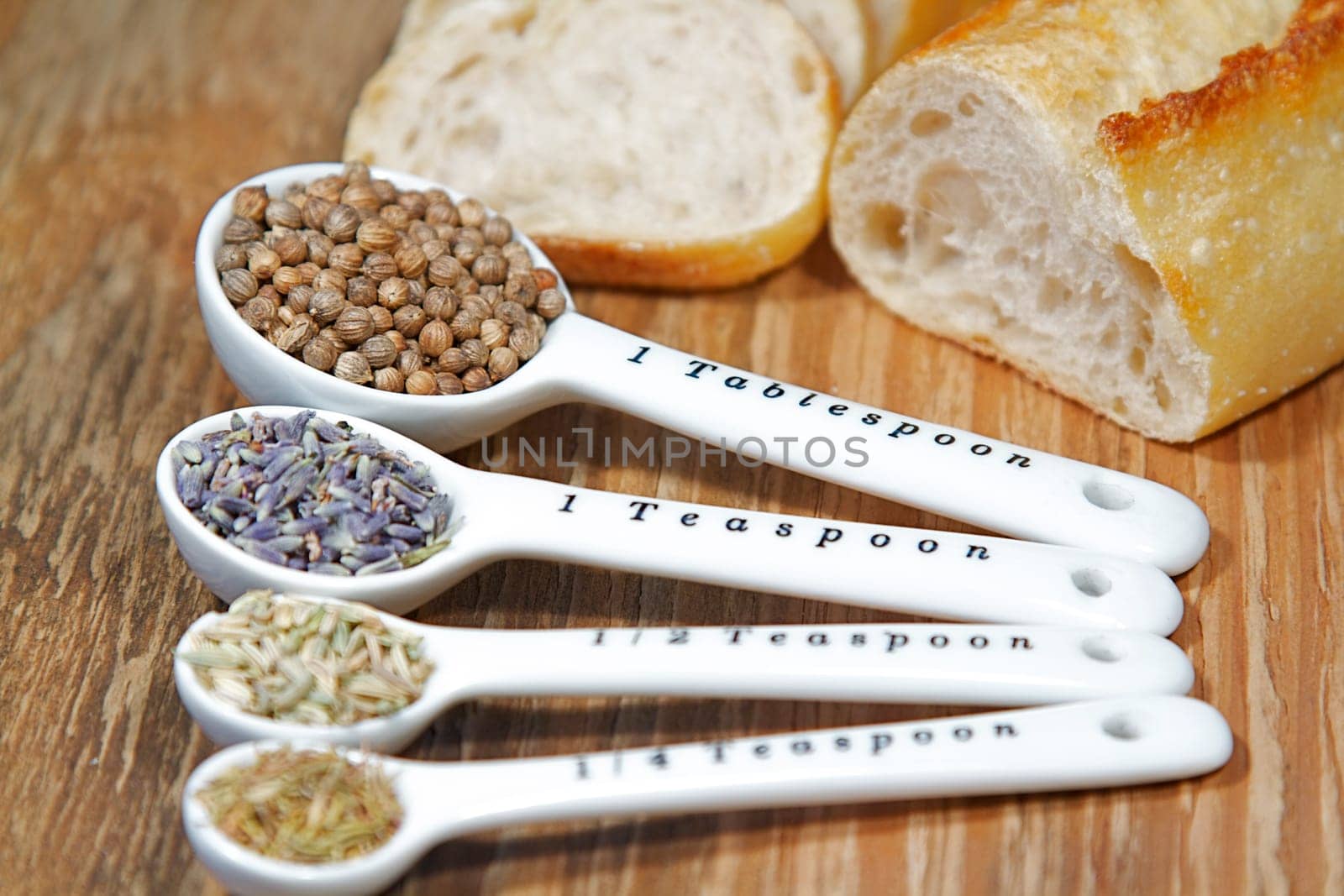 Old table-top selection of herbs and grains in measuring spoons