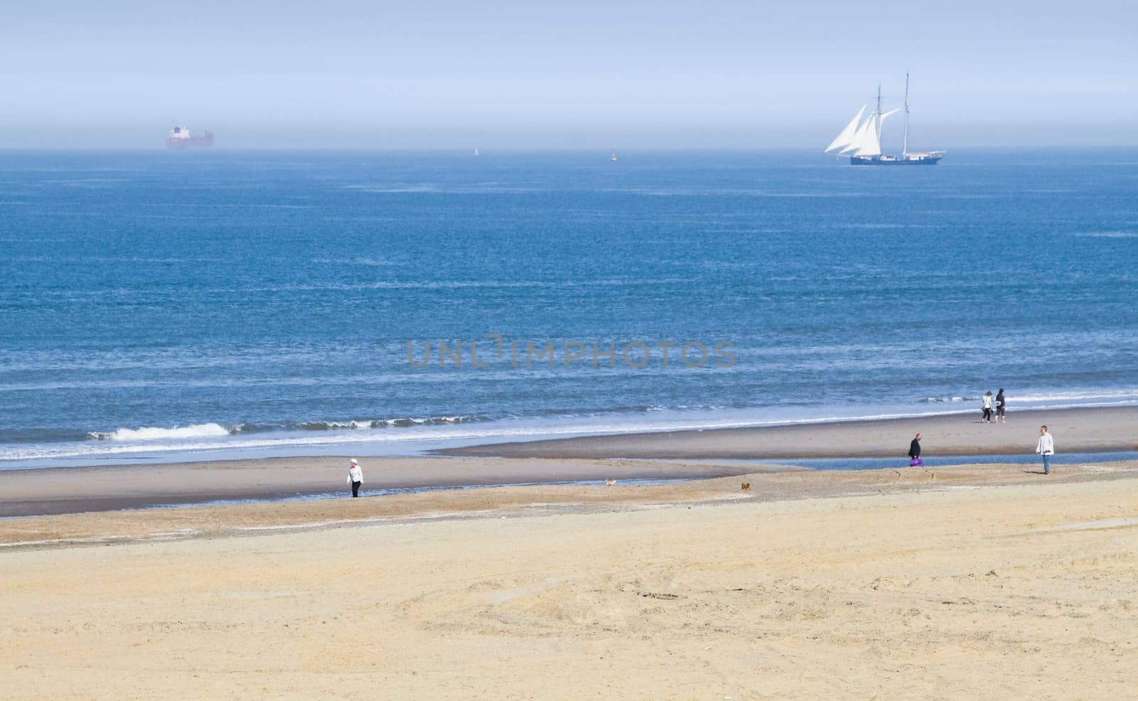 Rare phenomenon at the coast - sea with seamist or seaflame and warm sunshine on the beach